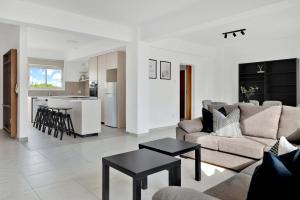 a living room with a couch and a table at Phaedrus Living: Romanou Modern City Center Flat in Nicosia