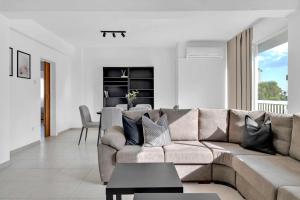 a living room with a couch and a table at Phaedrus Living: Romanou Modern City Center Flat in Nicosia +15 photos