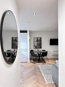 einen Spiegel im Wohnzimmer mit einem Tisch und Stühlen in der Unterkunft Marsh House - 2 bedroom apartment in the Heart of the City in Bristol