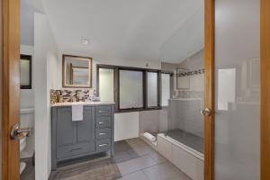 a bathroom with a shower and a sink and a tub at 406 Lodge-A: Hot-Tub & 2 Blks to Main St in Fredericksburg