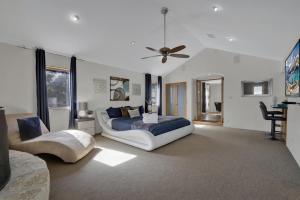 a bedroom with a bed and a ceiling fan at 406 Lodge-A: Hot-Tub & 2 Blks to Main St in Fredericksburg