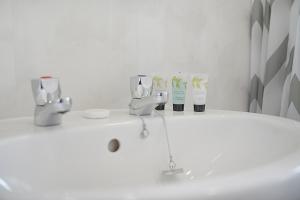 a bathroom with a sink with two faucets at Falmer Serene Getaway, Newly Refurbished, Sleeps 4 in Darlington