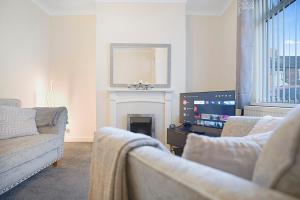 a living room with two couches and a tv at Falmer Serene Getaway, Newly Refurbished, Sleeps 4 in Darlington