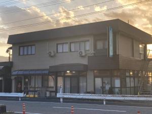 a large building on the side of a street at 11月フルリフォーム 12月オープン恐竜一色ゲストハウスDinosaur Guesthouse in Katsuyama