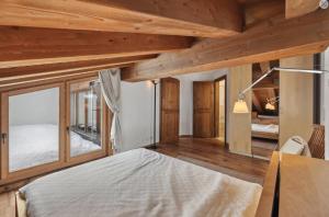 a bedroom with wooden ceilings and a bed in a room at Magnificent flat in Crans-Montana - 856 in Crans-Montana
