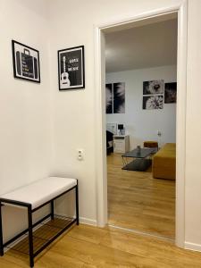 a room with a bench and a living room at Studio Apartment Dandelion in Bratislava