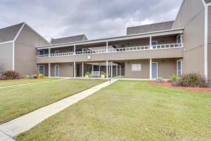 a large building with a lawn in front of it at Modern Panama City Beach Condo 5 Mi to Beaches! in Panama City Beach