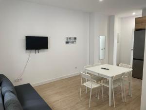uma sala de estar com uma mesa branca e cadeiras em U4 Apartamento a estrenar, centro Madrid em Madrid