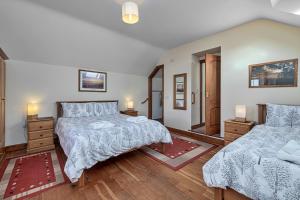 a bedroom with two beds and a mirror at Finest Retreats - Helygen in Talybont