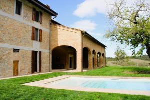 an external view of a building with a swimming pool at Villa Finetta - Tabiano Castello Country Villas in Salsomaggiore Terme
