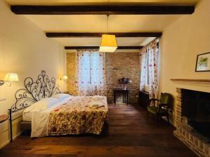 a bedroom with a bed and a fireplace at Villa Finetta - Tabiano Castello Country Villas in Salsomaggiore Terme