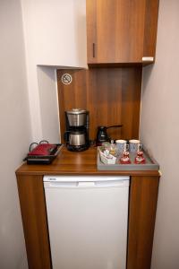 a kitchen counter with a coffee pot on top of a refrigerator at Deisisroom nafplio Afroditi in Nafplio
