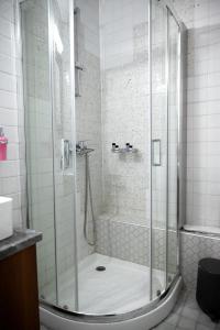 a shower with a glass door in a bathroom at Deisisroom nafplio Afroditi in Nafplio