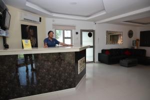 a man standing behind a counter in a living room at Hotel Ali Jose in Albania