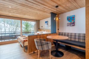 a bedroom with a bed and a table at TARDEVANT 21 in Le Grand-Bornand