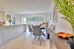 a kitchen and dining room with a table and chairs at Days Away - Luxury holiday home in Radipole