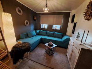 an overhead view of a living room with a blue couch at Aux champs des cloches in Houffalize