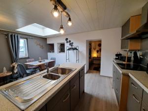 a kitchen with a sink and a counter top at Aux champs des cloches in Houffalize