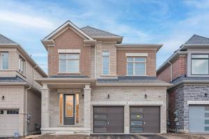 a brick house with a garage at Custom Build 5 Bedroom Villa (Ski Resort) in Midhurst