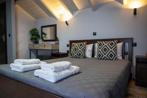a bedroom with a bed with white towels on it at Deisisroom nafplio poseidon in Nafplio