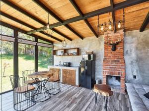 a kitchen with a table and chairs and a fireplace at Cabaña Petunia, Tapalpa in Tapalpa