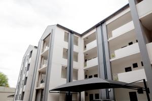 an umbrella sitting in front of a building at Evergreen On Lever in Midrand