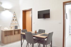 a dining room with a table and a christmas tree at Your Home, in the center of Bari in Bari