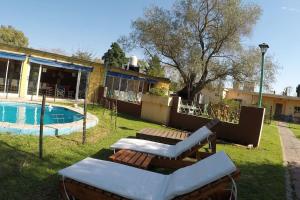 a resort with a swimming pool and a building at Quinta el Olivo con piscina en Buenos Aires in Alejandro Korn