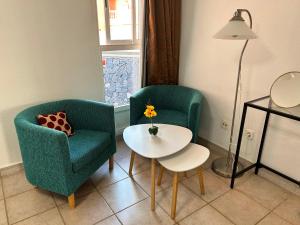 a living room with two chairs and a table at Nice apartment Duque Tenerife South in Adeje +12 photos