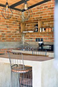 a kitchen with two chairs and a sink at Cabaña Lavanda, Tapalpa in Tapalpa +25 photos