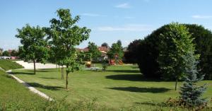 a park with trees and a playground with a slide at Studio tout équipé in Revigny-sur-Ornain