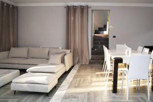 a living room with a white couch and a table at The Beachfront Villa by PikHost in Golem