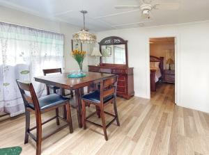 a dining room with a wooden table and chairs at Skylight Waterfront home w/ amazing view/dock/boat in Lancaster