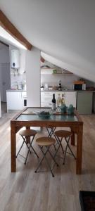 a kitchen with a wooden table and some chairs at Poolemonhouse in Fernao Ferro