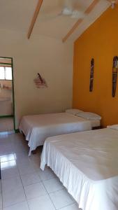 a room with two beds in a room at Cool & Calm Hotel in Manzanillo