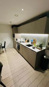 a kitchen with a sink and a counter top at Trendy & Chic Apartment In The Heart of London in London