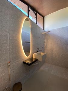 a bathroom with a sink and a mirror at CHALE VILAALICE in Monte das Gameleiras +22 photos