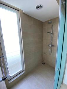 a bathroom with a shower and a window at Plaza Arkadia in Desa ParkCity in Kuala Lumpur