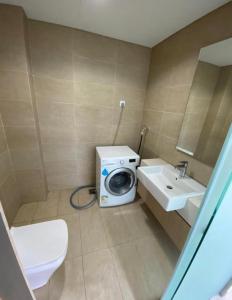 a bathroom with a washing machine and a sink at Plaza Arkadia in Desa ParkCity in Kuala Lumpur