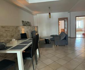 a living room with a table and chairs and a couch at Apartmán Rebeka in Liptovský Mikuláš