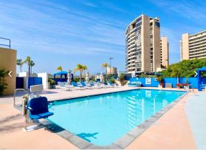 a large swimming pool with chairs and a building at Fantastic Marina View in Front of My Window! in Los Angeles