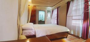 a bedroom with a bed with a large mirror at Mia Safari Lodge and Restaurant in Entebbe