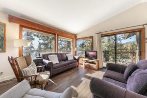 a living room with couches and a tv at Tahoe Vista Retreat with Lake View Walk to beach in Tahoe Vista