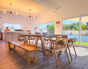 comedor con mesa de madera y sillas en Villa Juliana Monterrico, en Taxisco