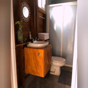 a bathroom with a sink and a toilet at Caba&ntilde;as Chac Mool Downtown in Holbox Island