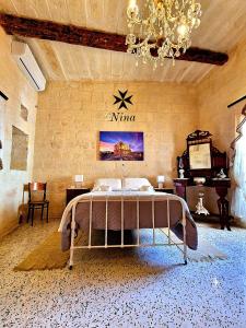 a bedroom with a bed in a room with a piano at Nina in Siġġiewi