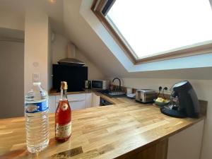 a bottle of water sitting on top of a kitchen counter at Studio cosy - renove - calme - 3 personnes - proche gare et centre historique in Quimper +13 photos