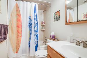 a bathroom with a toilet and a shower curtain at Downtown Berlin Condo about 10 Mi to Ocean City Beach! in Berlin +16 photos