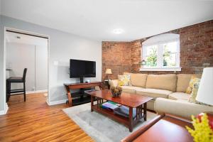 a living room with a couch and a table at City Living In the Heart of 4th Ward~1BD 1BA in Charlotte