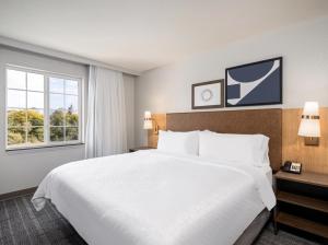 a hotel room with a large bed and a window at Staybridge Suites Rochester University, an IHG Hotel in Rochester